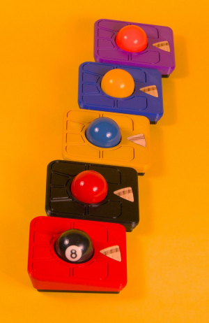 A line up of Ploopy Adept trackballs in various colours and with one featuring an 8-ball as the trackball